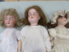 THREE ARMAND MARSEILLE BISQUE HEADED MODEL 390 DOLLS, THE TALLEST. H 65cms.