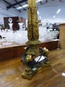 A GILT BRONZE COLUMNAR TABLE LAMP, THE REEDED COLUMN FLARING TO FOLIAGE CAST AT THE BASE SUPPORTED