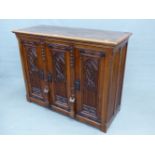 A 19th.C. OAK GOTHIC REVIVAL CABINET WITH THREE CARVED PANEL DOORS. 129 x 53 x 102cms (H).