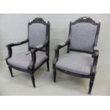 A PAIR OF BLACK PAINTED LOUIS XVI STYLE SHOW FRAME ELBOW CHAIRS, THE FOLIAGE CRESTED BACKS