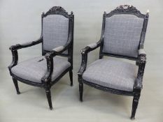 A PAIR OF BLACK PAINTED LOUIS XVI STYLE SHOW FRAME ELBOW CHAIRS, THE FOLIAGE CRESTED BACKS