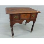 AN 18th.C. AND LATER OAK LOWBOY WITH THREE DRAWERS TO DECORATIVE SHAPED FRIEZE STANDING ON TURNED