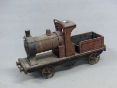 A RED PAINTED WOOD PULL ALONG STEAM ENGINE WITH SPOKED IRON WHEELS AND BEARING ALUMINIUM TRIANGLE ON