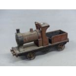 A RED PAINTED WOOD PULL ALONG STEAM ENGINE WITH SPOKED IRON WHEELS AND BEARING ALUMINIUM TRIANGLE ON