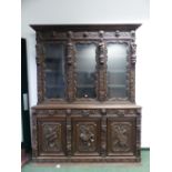 A VICTORIAN CARVED OAK LARGE GLAZED BOOKCASE, THREE GLAZED UPPER DOORS WITH FIGURAL PILLASTERS