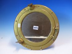 A BRASS PORTHOLE NOW FITTED WITH MIRRORED GLASS, THE FRAME. Dia. 30cms.