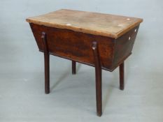 AN ANTIQUE OAK DOUGH BIN, THE SINGLE PLANK TOP AND JOINTED SIDES ON SHAPED SQUARE SECTIONED LEGS.