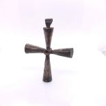 A BYZANTINE WHITE METAL PENDANT CROSS, THE CONICAL ARMS CENTRED BY A CABOCHON. H 5.5cms.