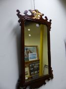 A RECTANGULAR MIRROR IN MAHOGANY CUT WORK FRAME CRESTED BY A GILT EAGLE. 102 x 55cms.