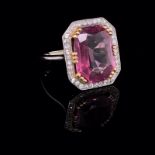 A DIAMOND AND PINK GEMSTONE LARGE COCKTAIL RING, THE CENTRAL PINK GEM/QUARTZ FACET CUT HELD WITH SIX