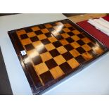 A PARQUETRIED ROSEWOOD FOLDING CHESS AND BACKGAMMON BOARD, THE LATTER WITH ALTERNATING WHITE AND