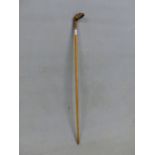 A GOLF CLUB HANDLED WALKING STICK, THE STRIKING FACE INLAID OPPOSITE LEAD WEIGHTING