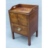 A GEORGIAN MAHOGANY NIGHT TABLE, THE THREE QUARTER GALLERY PIERCED WITH HANDLES ABOVE A CUPBOARD