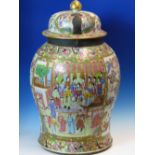 A 19th C. CANTON COVERED JAR, THE BALUSTER BODY PAINTED WITH TWO RESERVES OF FIGURES AGAINST A