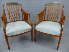 A PAIR OF NEOCLASSICAL STYLE PAINTED SATIN WOOD ARMCHAIRS, THE TOP RAILS PAINTED WITH VILLAGE SCENES