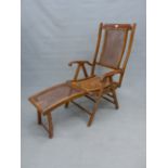 AN ADJUSTING CANED MAHOGANY DECK ARMCHAIR WITH FOOT REST, BRASS LABEL.