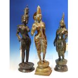 THREE SRI LANKHAN BRONZE FIGURES OF PARVATI STANDING, ONE WITH A BIRD IN HER RIGHT HAND. H 55cms.