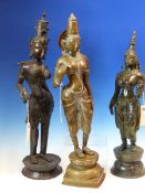 THREE SRI LANKHAN BRONZE FIGURES OF PARVATI STANDING, ONE WITH A BIRD IN HER RIGHT HAND. H 55cms.