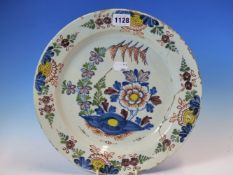 AN 18th C. ENGLISH DELFT POLYCHROME PLATE, THE CENTRAL GARDEN ENCLOSED BY FOUR FLORAL VIGNETTES ON