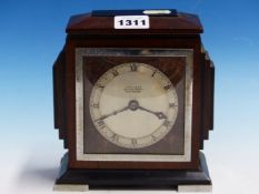 AN ART DECO MAHOGANY AND EBONY CASED MANTEL CLOCK RETAILED BY J HALL & Co. MANCHESTER, THE TIMEPIECE