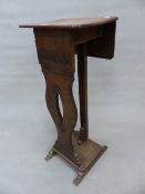 A 19th C. OAK FLAP TOP TORCHERE, A BAND OF FLUTING TO THE APRON ABOVE THE BALUSTER FRONT PIERCED