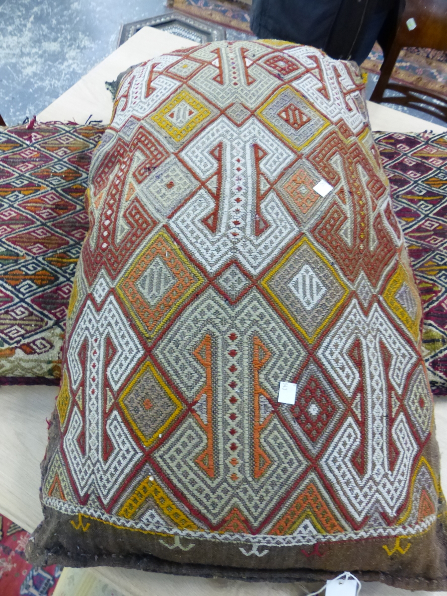 TRIBAL FLAT WEAVE SADDLE BAG MOUNTED AS A CUSHION. LENGTH OVERALL 124cm, TOGETHER WITH ANOTHER