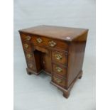 A GEORGE III MAHOGANY KNEEHOLE DESK WITH A LONG DRAWER OVER THE CENTRAL RECESSED CUPBOARD FLANKED BY
