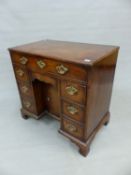 A GEORGE III MAHOGANY KNEEHOLE DESK WITH A LONG DRAWER OVER THE CENTRAL RECESSED CUPBOARD FLANKED BY