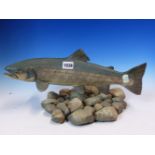A 1985 POTTERY MODEL OF A SEAT TROUT SWIMMING OVER PEBBLES, SIGNED BY NEIL DALRYMPLE. W 41cms.