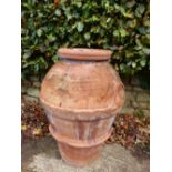 A TWO HANDLED ROMAN TERRACOTTA POT OF RIBBED OVOID SHAPE, THE INTERIOR GLAZED, THE RIM. H 84cms.