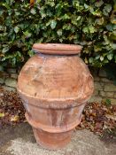 A TWO HANDLED ROMAN TERRACOTTA POT OF RIBBED OVOID SHAPE, THE INTERIOR GLAZED, THE RIM. H 84cms.