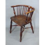 A YEW AND OAK WINDSOR CHAIR, SADDLE SEAT, THE TURNED LEGS JOINED BY A CRINOLINE STRETCHER.