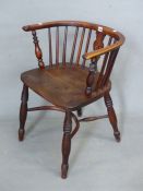 A YEW AND OAK WINDSOR CHAIR, SADDLE SEAT, THE TURNED LEGS JOINED BY A CRINOLINE STRETCHER.