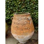 A TERRACOTTA ROMAN URN WITH THREE LUG HANDLES TO THE BELLIED SHAPE, THE RIM. Dia. 51 x H 112cms.