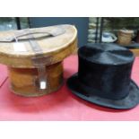 A WINE RED VELVET LINED LEATHER CASED KERR AND MCKENZIE TOP HAT WITH BLACK SILK PILE, THE INTERIOR