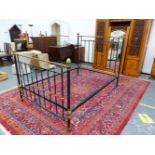 A VICTORIAN HEAL AND SON BRASS MOUNTED IRON DOUBLE BED, THE TUBULAR TOP RAILS EACH ABOVE NINE BLACKE