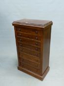 AN ANTIQUE MAHOGANY CHEST OF EIGHT DRAWERS EACH WITH KNOB HANDLES AND ABOVE THE PLINTH FOOT. W 56.5