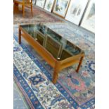 A MYER SMOKED GLASS TOPPED MAHOGANY COFFEE TABLE WITH A TIER BETWEEN LEGS OF QUARTER ROUND