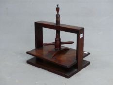 A 19th C. MAHOGANY BOOK PRESS, THE SCREW OF THE TWO HANDLED CLAMP TOPPED BY AN URN FINIAL, THE CLAMP