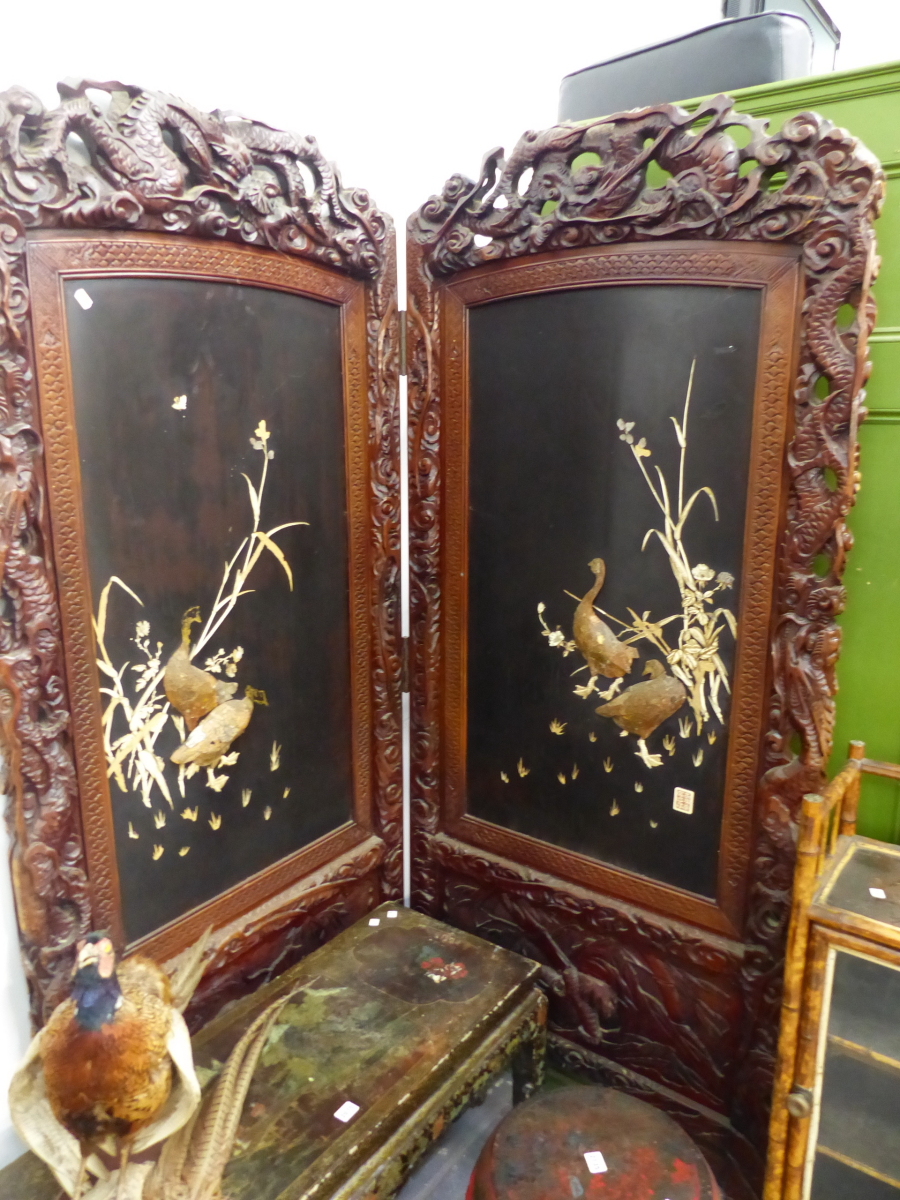 A LARGE LATE VICTORIAN ORIENTAL CARVED TWO FOLD SCREEN WITH IVORY AND LACQUER PANELS. EACH PANEL