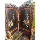 A LARGE LATE VICTORIAN ORIENTAL CARVED TWO FOLD SCREEN WITH IVORY AND LACQUER PANELS. EACH PANEL