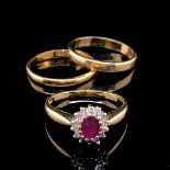 AN 18ct GOLD RUBY AND DIAMOND OVAL CLUSTER RING, FINGER SIZE K, TOGETHER WITH AN 18ct GOLD WEDDING