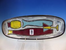 A LEAPER, NEWLYN ROUNDED RECTANGULAR DISH ENAMELLED WITH WINE STYLISED FISH AND A COCKTAIL GLASS.