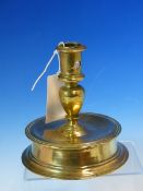 A 15th/16th C. BRASS CANDLESTICK THE CYLINDRICAL NOZZLE WITH CANDLE STUB EJECTION HOLE BETWEEN TWO