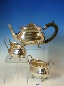 AN EDWARDIAN SILVER HALLMARKED THREE PART TEA SET, COMPRISING OF A TEA POT, SUGAR BASIN, AND