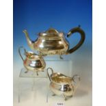 AN EDWARDIAN SILVER HALLMARKED THREE PART TEA SET, COMPRISING OF A TEA POT, SUGAR BASIN, AND