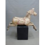 A RARE 19TH CENTURY CARVED WOOD CAROUSEL FIGURE OF A GALLOPING FAIR GROUND HORSE. WITH REMNANTS OF