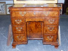 AN ANTIQUE BURR WALNUT KNEEHOLE DESK. QUARTER VENEERED TOP OVER ARRANGEMENT OF EIGHT DRAWERS