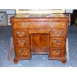 AN ANTIQUE BURR WALNUT KNEEHOLE DESK. QUARTER VENEERED TOP OVER ARRANGEMENT OF EIGHT DRAWERS