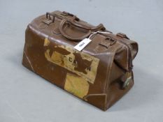 A BROWN LEATHER GLADSTONE TYPE TRAVEL BAG SECURED BY A CREST METAL ZIP AND LOCK AND TWO FURTHER